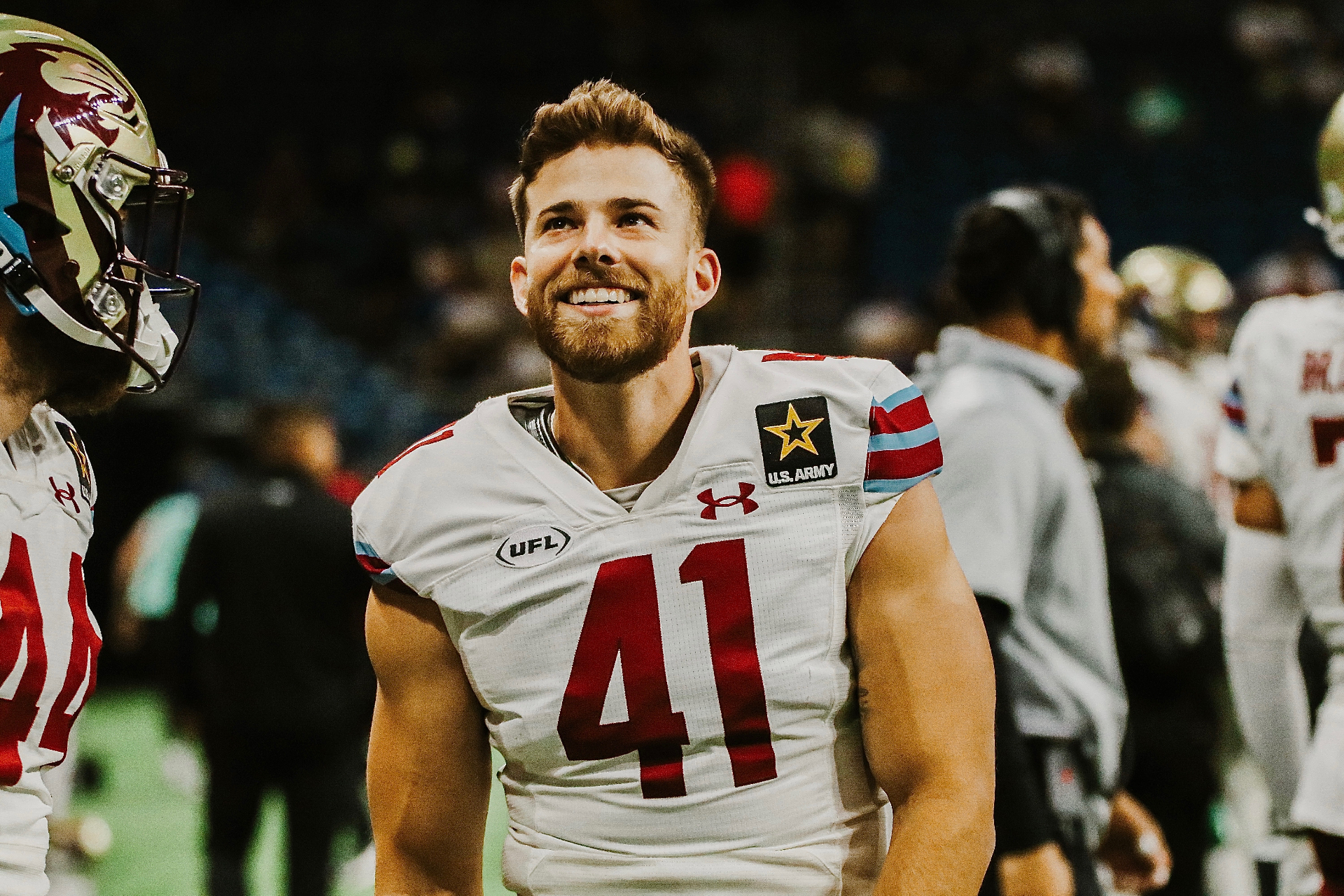 Brock Miller smiling on the sideline in a UFL uniform